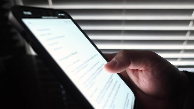 Close up of male hand scrolling through articles on phone 2