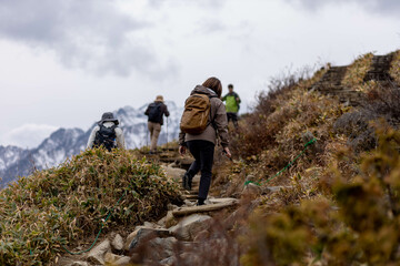 Hakuba, Japan - 4 November 2023 : Hikers walking on a rocky surface on a moutain at Hakuba, Japan.