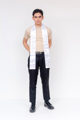Confident and stylish man in a pageant setting, wearing a sash and poised stance, ready for...