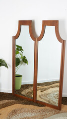 Vintage Double Arched Wall Mirror. Mid-Century Modern
walnut furniture. Interior photograph with...