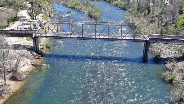 North Fork of the American River at the gold discovery site in Coloma, California showing the rapids and the Sutter Bridge. 