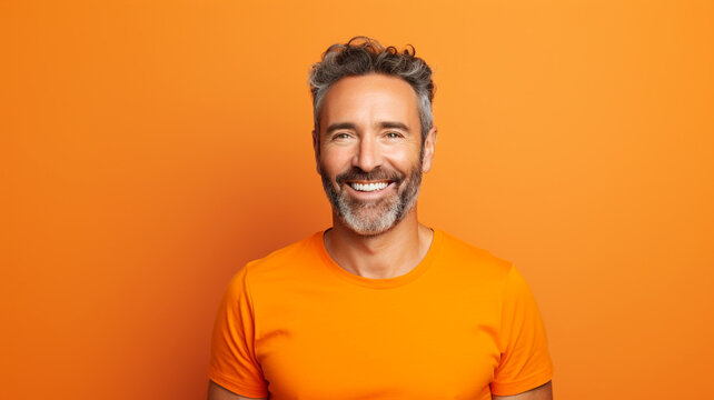 Happy smiling middle aged adult man on a solid background
