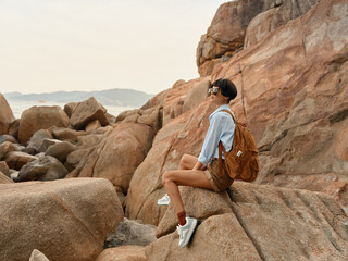 Happy Traveler: Woman Backpacking on a Tropical Beach at Sunset, Smiling and Enjoying the Adventure