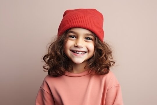 Portrait of a cute little girl in a red hat, studio shot