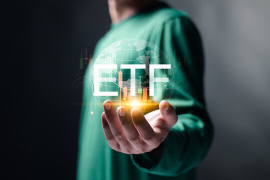ETF, Exchange traded fund. Financial technology business investment concept. Person hold globe and stock market growth graph on virtual screen.