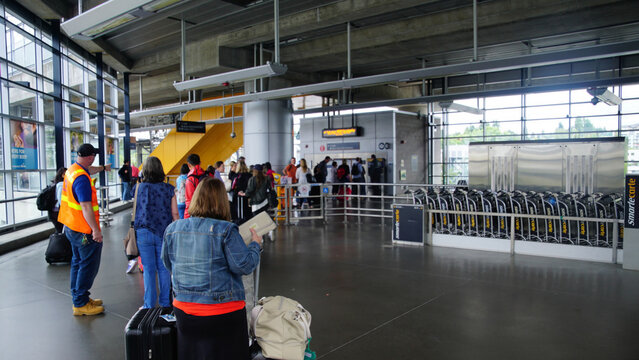Passengers queue to  buy transit tickets