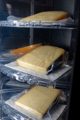 Sell of fresh farm cheese in automatic vending machine on organic cheese farm in Netherlands