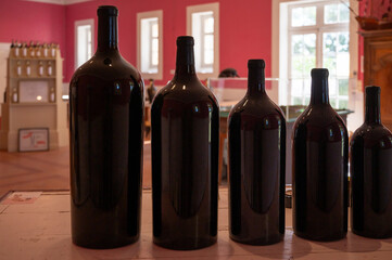 Different sizes of bottles of red Bordeaux wine in tasting room, wine domain in Haut Medoc, wine...