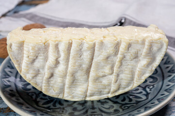 French soft Camembert cheese, original Camembert de Normandie, close up with white mold