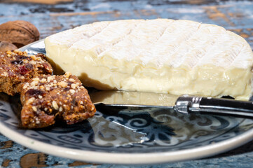 French soft Camembert cheese, original Camembert de Normandie, close up with white mold