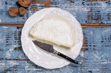 French soft Camembert cheese, original Camembert de Normandie, close up with white mold