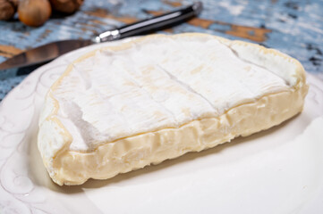 French soft Camembert cheese, original Camembert de Normandie, close up with white mold