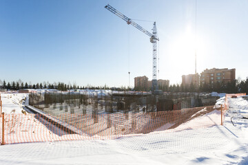 the construction site of an apartment building in the winter from a height