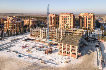 the construction site of an apartment building in the winter from a height