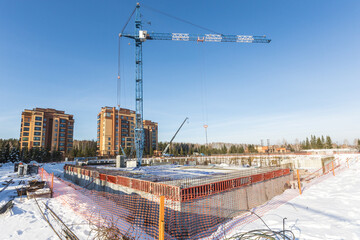 the construction site of an apartment building in the winter from a height