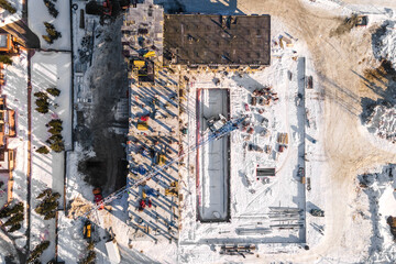 the construction site of an apartment building in the winter from a height