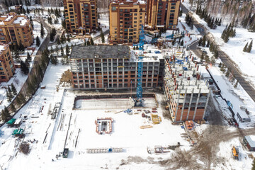 the construction site of an apartment building in the winter from a height