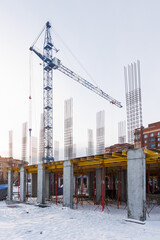 the construction site of an apartment building in the winter from a height