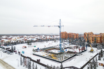 the construction site of an apartment building in the winter from a height