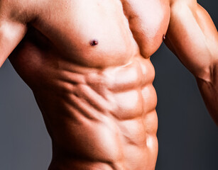 Fototapeta premium Male model with perfect body. Seductive gay. Close up Male chest. Chest muscles. Muscled male torso with abs. Athletic Man showing muscular body and six pack abs. Sexy naked man, seductive guy.