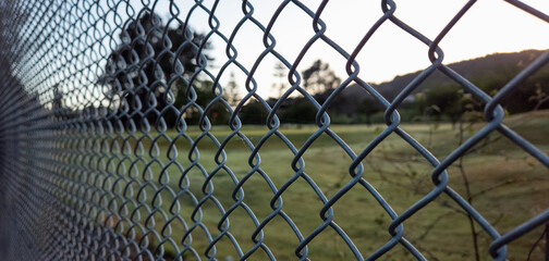 Chainlink fence at sunrise