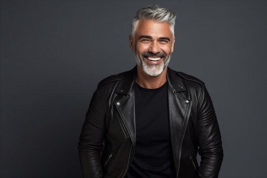Portrait of a smiling middle-aged man in a leather jacket.