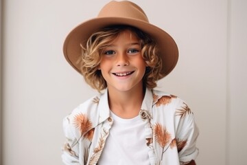 Portrait of a cute smiling little boy in hat looking at camera