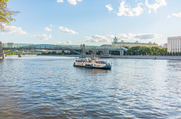 View of the Moscow river embakment, Pushkinsky bridge and cruise ships at sunset.