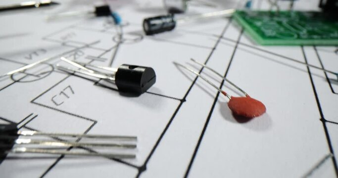 Various electronic parts and components on background of printed circuit board diagram with resistors