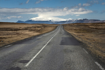 Scenic country road towards beautiful Snaefellsjokull glacier in the west of Iceland during midday