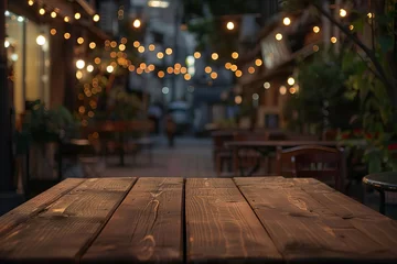 Foto op Aluminium Outdoor caf scene with an empty wooden table and ambient bokeh lights Setting the stage for a cozy urban evening © Jelena