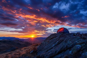 Secluded mountain camping A tent perched on a rocky ledge overlooking a breathtaking sunset Embodying adventure and solitude in the wilderness Vibrant sky reflecting the day's end