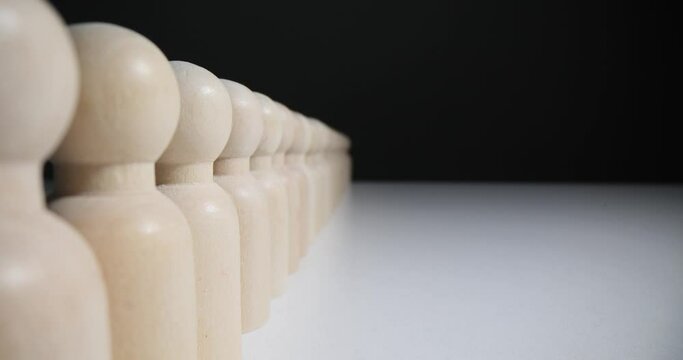 Identical wooden figures concept of uniformity