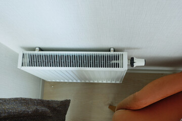 White radiator on grey white wall. apartment heating installation system, 