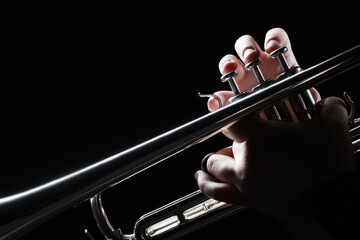 Trumpet player hands playing brass instrument - 745547443