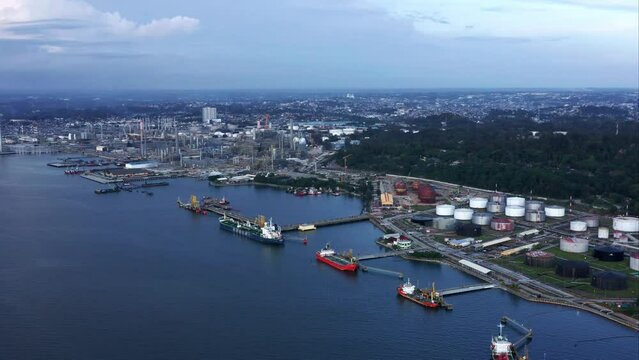 Rising view of Docked Oil Tanker Ships and Pertamina Oil Refinery in the background - Port of Balikpapan City, Indonesia