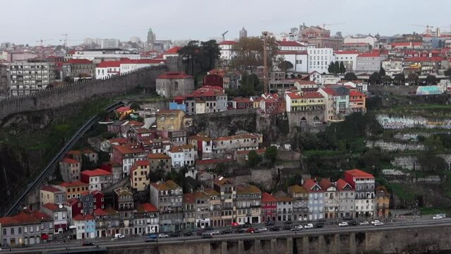 Old colorful buildings of Porto next to Muralha Fernandina and Dos Guindais Cable Car