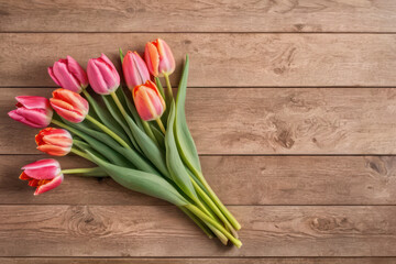 top view of beautiful tulips on wooden table