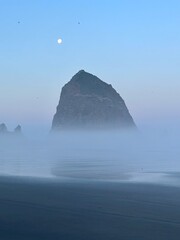 misty sunset looking at Haystack Rock on Cannon Beach in Oregon