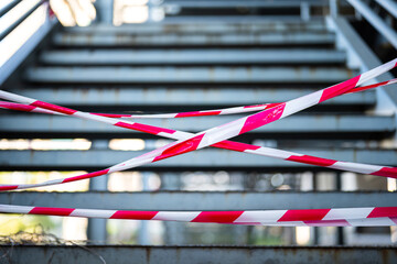 Close-up at the red-white barricade tape, using for secure the restricted area with background of...