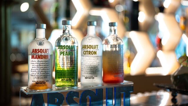 Thailand - 22 February 2024: Absolut Vodka, the famous Swedish liquor brand, in various taste and smell in glass bottled are placed on the counter bar. Prepared to serve for drinker.