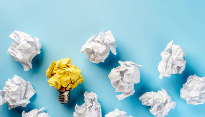 A bright idea concept, yellow crumpled paper light bulb amidst white crumpled papers on a blue background, symbolizing ideas, brainstorming, and creativity.