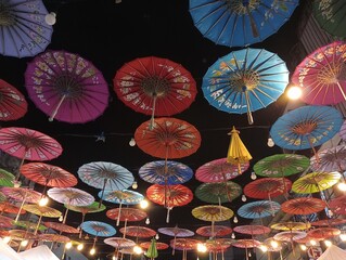 Lots of umbrellas coloring the sky in the festive city. Colorful umbrella carnival decoration in...