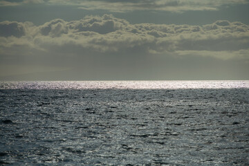 Obraz premium Summer sea background. Texture of water surface. Shining blue water ripple pattern.