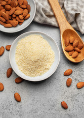 Fresh almond flour in a  bowl and almonds