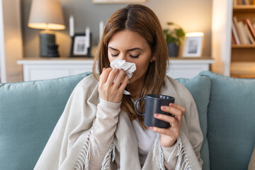 Sickness, seasonal virus problem concept. Woman being sick having flu lying on sofa. Sick woman...