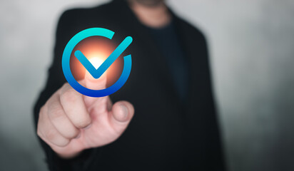 Man in suit hand touch a sign of checkmark to standard quality control certification assurance...