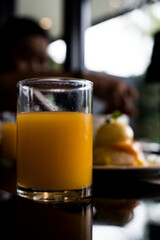 A glass of sweet fresh orange juice on the table