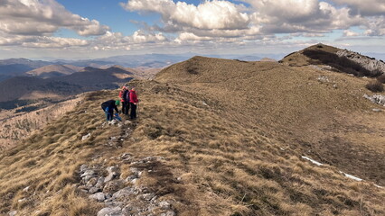 Fototapeta premium Small group of senior hikers on the mountain ridge