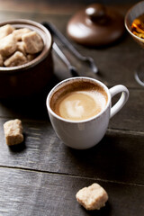 Cup of coffee on wooden background. Close up.